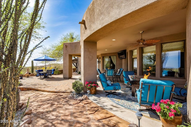 view of patio featuring outdoor dining space and a ceiling fan