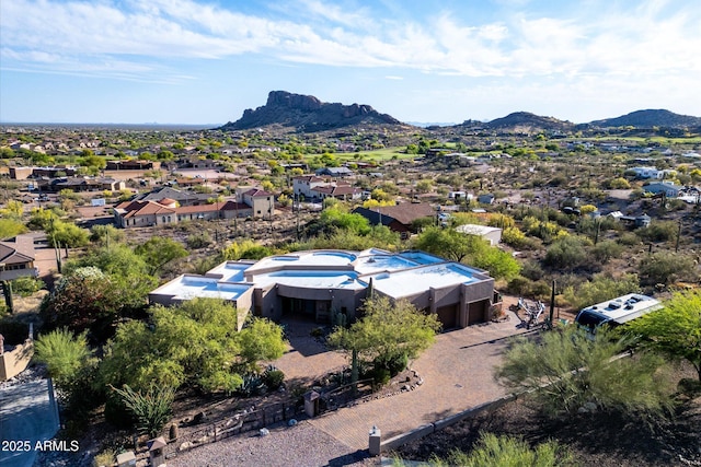 aerial view of residential area featuring a mountainous background