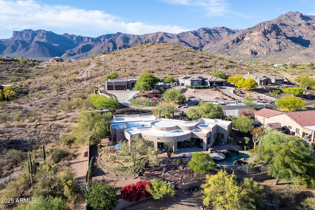 aerial view of property and surrounding area featuring a mountain backdrop