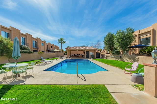 pool with a lawn, a patio, a residential view, fence, and a gazebo