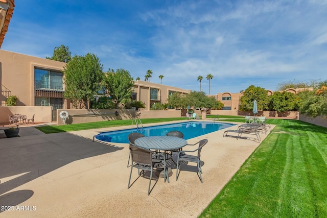 view of swimming pool featuring a patio area, fence, a fenced in pool, and a yard