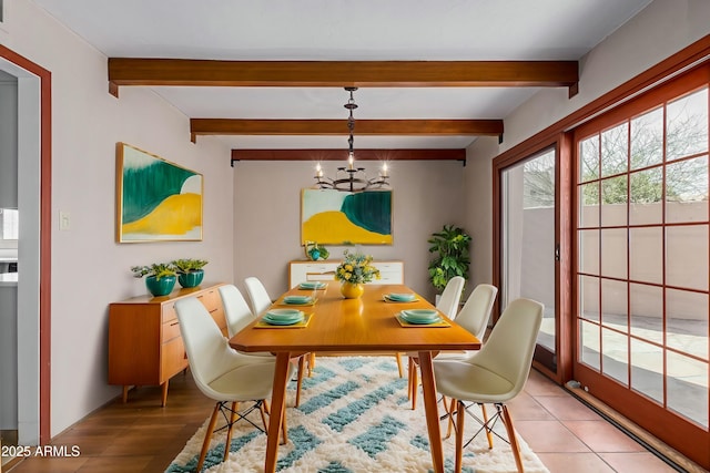 dining area with a notable chandelier, beamed ceiling, and tile patterned floors