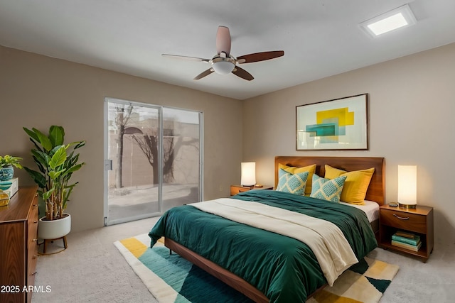 bedroom with access to exterior, light carpet, and a ceiling fan