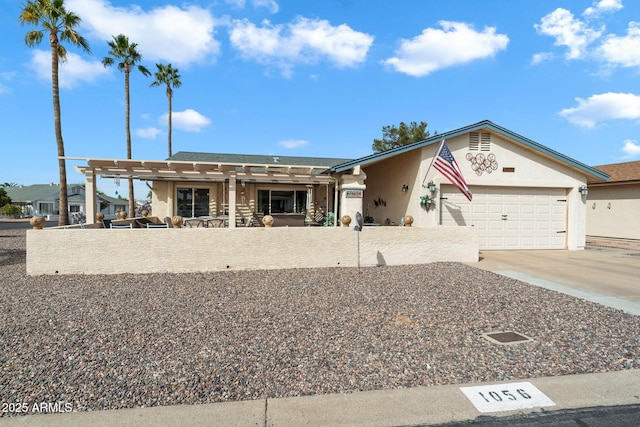 ranch-style house with concrete driveway, an attached garage, and stucco siding