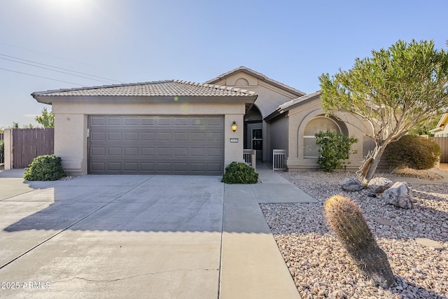 single story home featuring driveway, stucco siding, central air condition unit, a garage, and a tiled roof