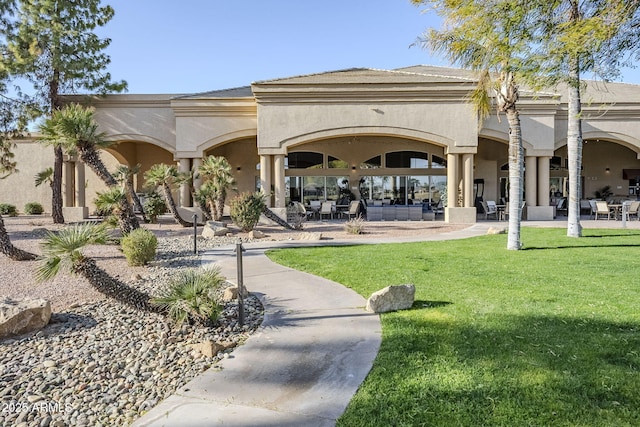 view of home's community featuring a patio area and a lawn