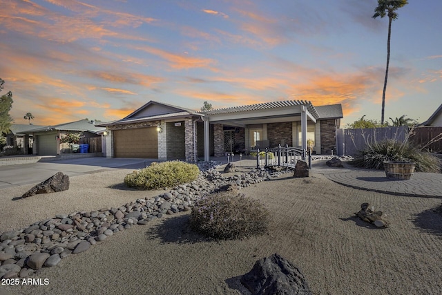 ranch-style home with a garage and a pergola