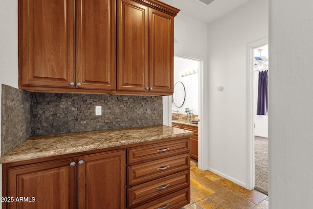 kitchen featuring light stone counters and decorative backsplash