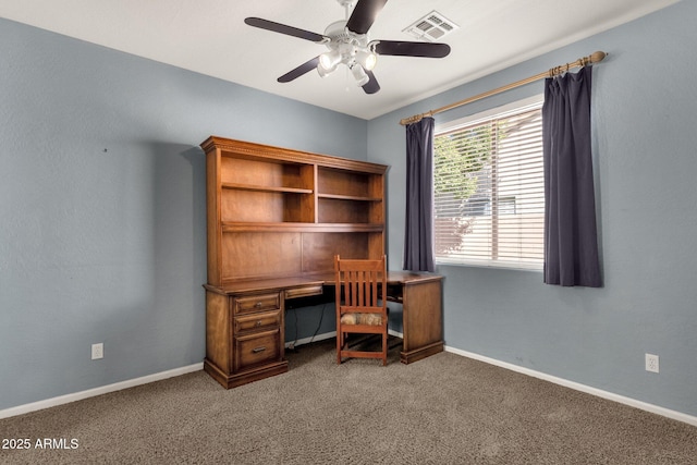 unfurnished office with dark colored carpet and ceiling fan