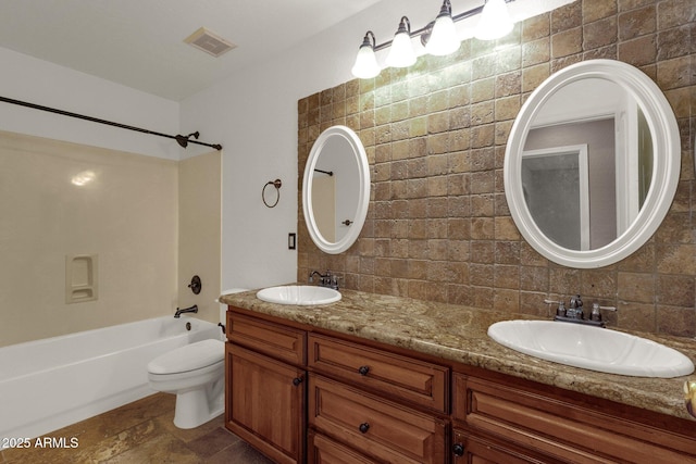 full bathroom featuring vanity, decorative backsplash, toilet, and washtub / shower combination