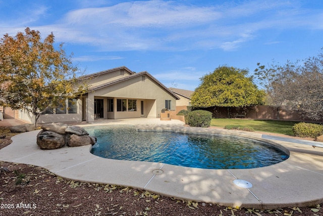 view of pool featuring a diving board and a patio