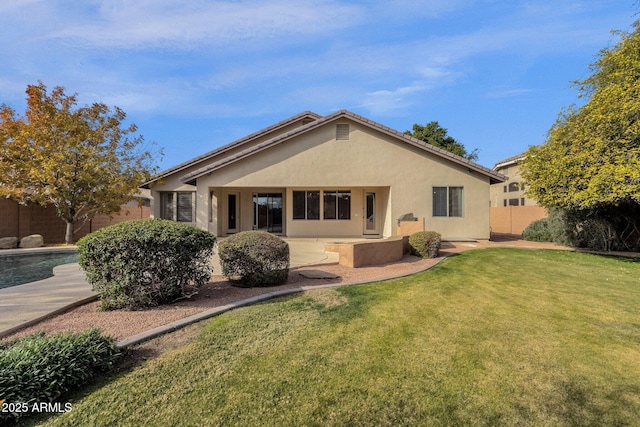 rear view of property with a lawn