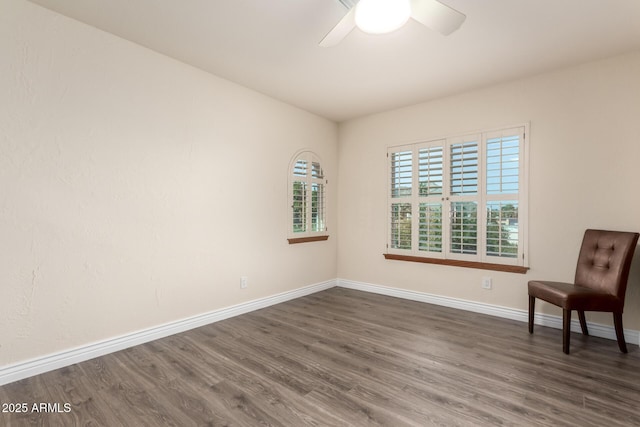 unfurnished room featuring dark hardwood / wood-style floors and ceiling fan