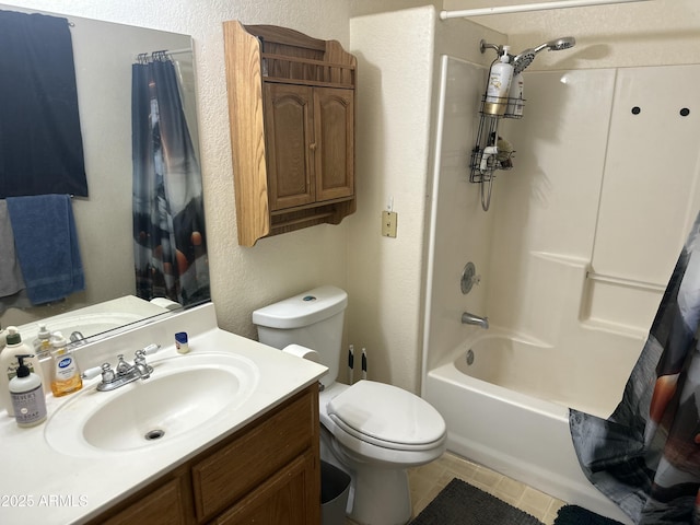 bathroom with a textured wall, tile patterned flooring, toilet, shower / tub combo, and vanity