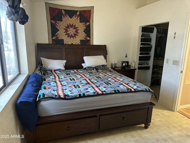 bedroom featuring a walk in closet and a closet