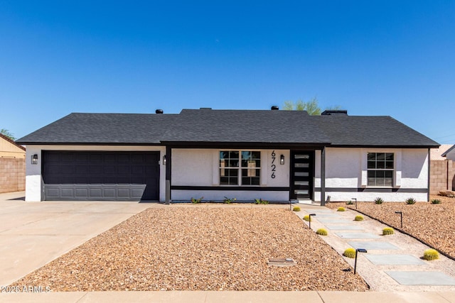 ranch-style home featuring stucco siding, concrete driveway, a shingled roof, and a garage