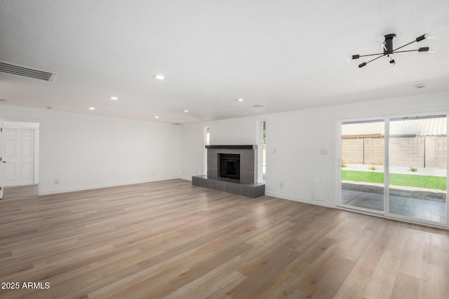 unfurnished living room featuring baseboards, visible vents, light wood-style floors, and recessed lighting