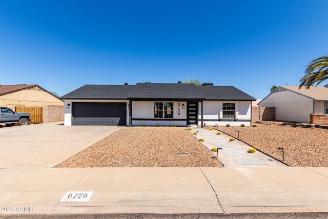 single story home with stucco siding, concrete driveway, and a garage