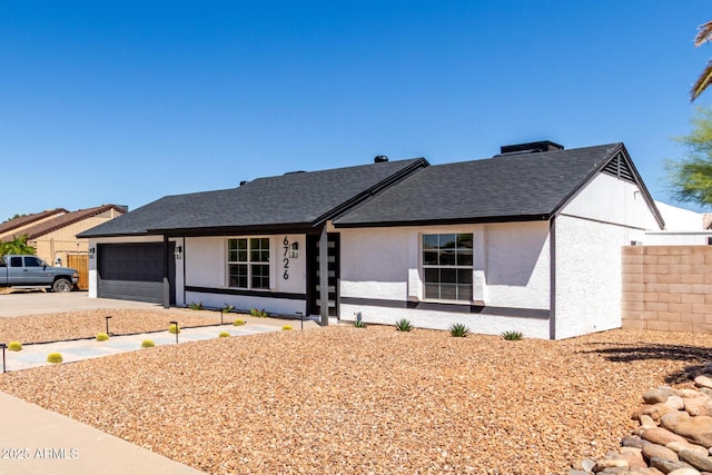 ranch-style home featuring stucco siding, a shingled roof, concrete driveway, and an attached garage