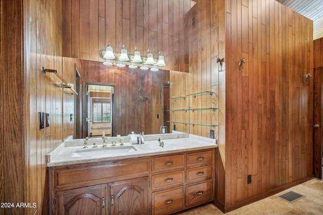 bathroom featuring vanity and wood walls