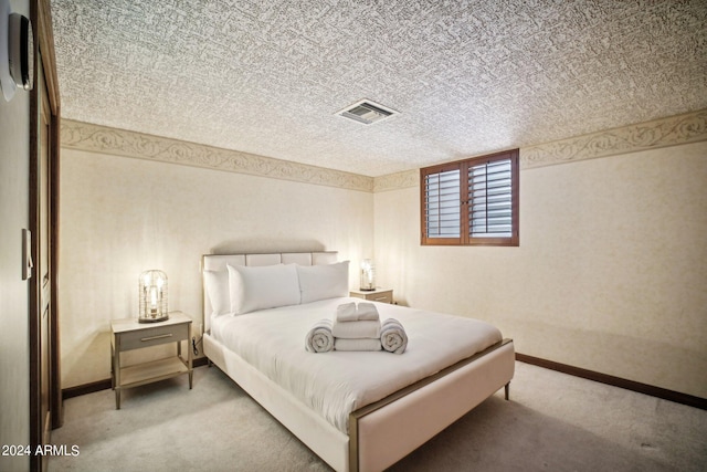 carpeted bedroom with a textured ceiling