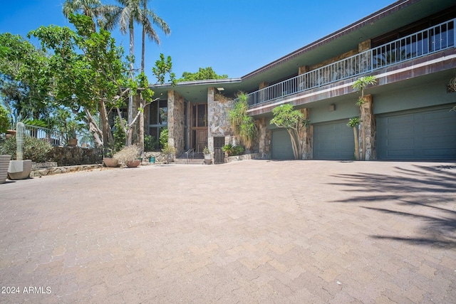 view of front facade featuring a balcony and a garage