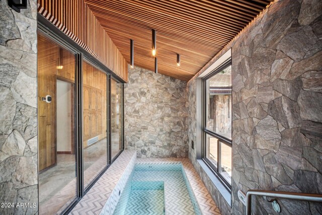 interior space featuring wooden ceiling