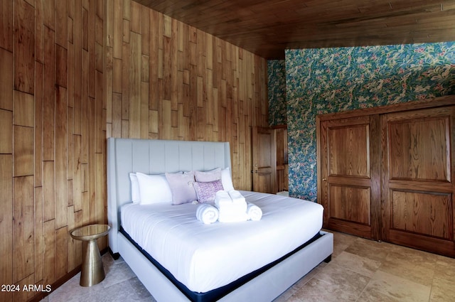 bedroom featuring wood walls and wood ceiling