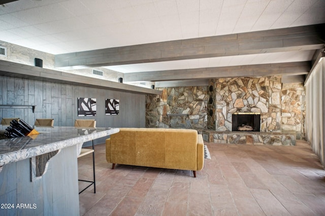 living room with wooden walls, a fireplace, and wood-type flooring