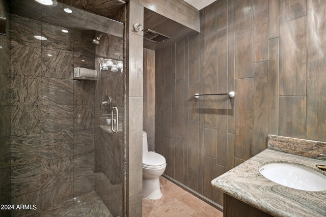 bathroom featuring vanity, toilet, and a shower with shower door