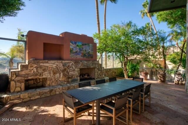 view of patio with an outdoor stone fireplace