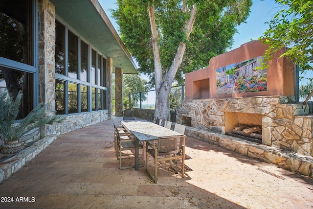 view of patio / terrace with an outdoor stone fireplace