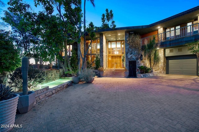 property entrance with a garage and a balcony