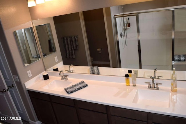 bathroom featuring vanity, toilet, and an enclosed shower