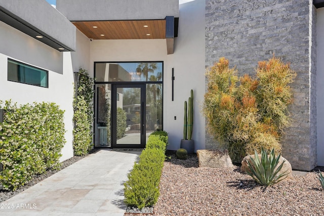 entrance to property with stucco siding