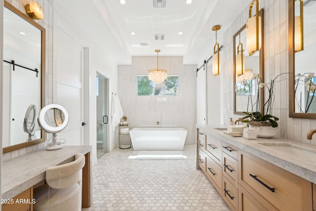 bathroom featuring a sink, a freestanding tub, a shower stall, and visible vents