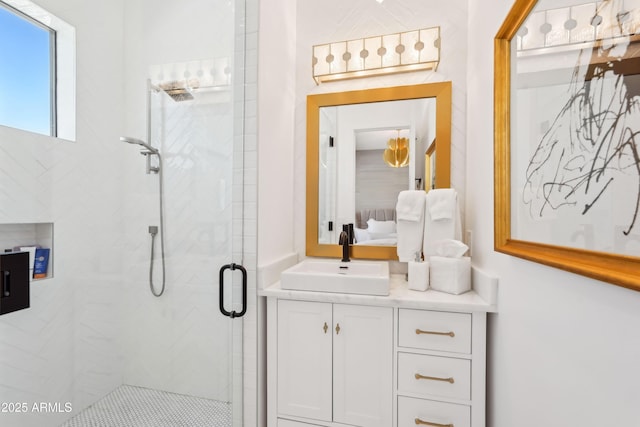 bathroom with connected bathroom, a shower stall, and vanity