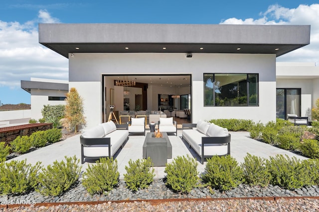 back of property featuring a patio, outdoor lounge area, and stucco siding