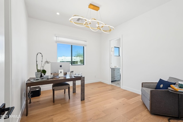 home office featuring recessed lighting, baseboards, light wood-type flooring, and a chandelier