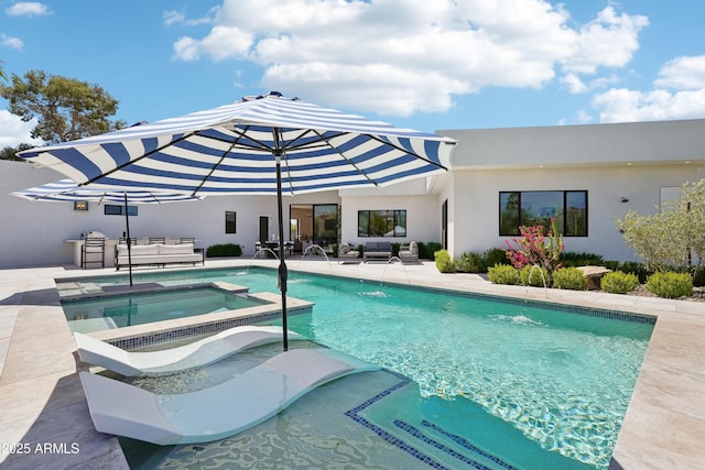 view of swimming pool featuring a pool with connected hot tub, a patio area, and outdoor lounge area