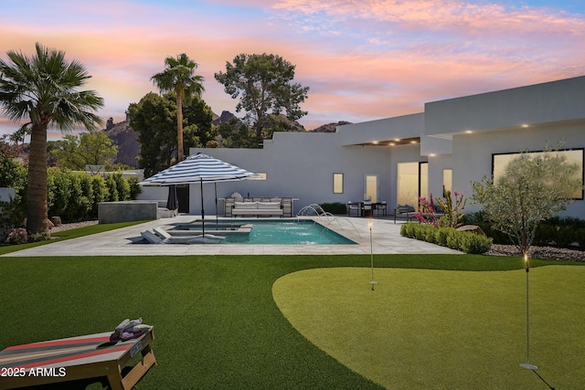 pool with a patio area and an in ground hot tub
