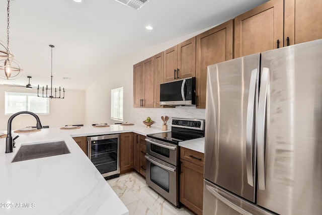 kitchen with beverage cooler, tasteful backsplash, appliances with stainless steel finishes, marble finish floor, and a sink