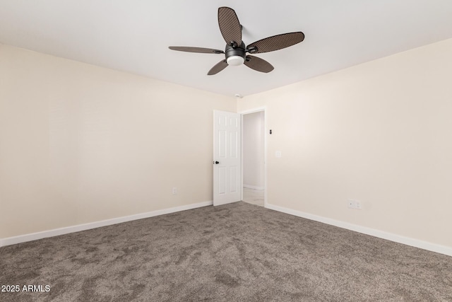 carpeted empty room featuring ceiling fan and baseboards