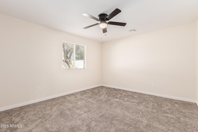 carpeted empty room with a ceiling fan, visible vents, and baseboards