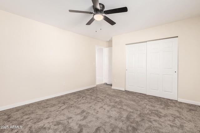 unfurnished bedroom with ceiling fan, carpet floors, a closet, and baseboards