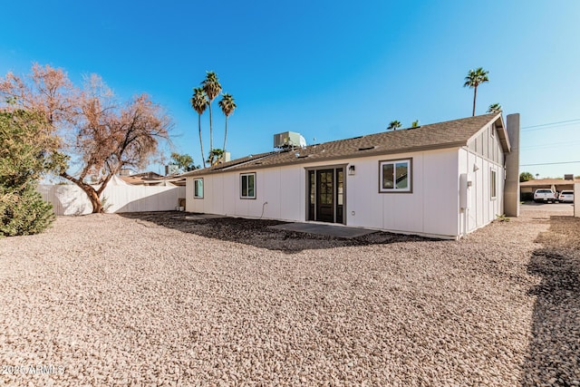 rear view of house featuring a patio, cooling unit, and fence