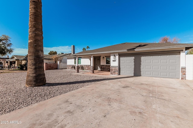 view of front facade featuring concrete driveway, stone siding, an attached garage, and stucco siding