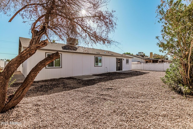 rear view of property featuring fence