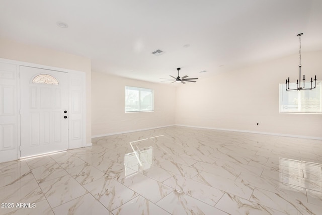 foyer entrance featuring ceiling fan with notable chandelier, marble finish floor, visible vents, and baseboards