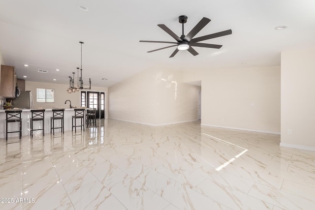 interior space featuring recessed lighting, a sink, visible vents, baseboards, and marble finish floor